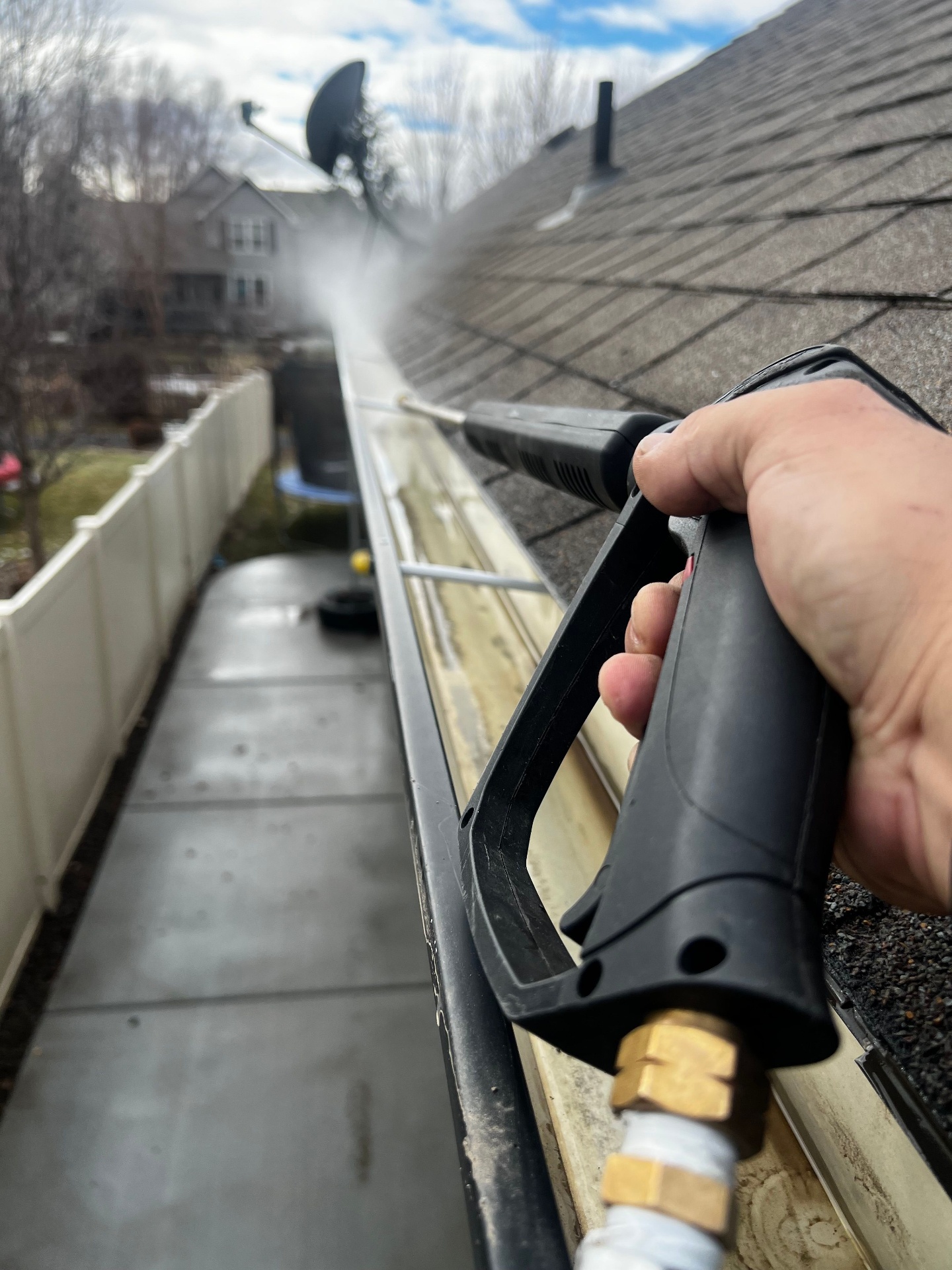 Cleaning gutters with pressure washer